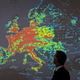 A man stands in front of a picture displaying activities of a so-called “botnet” during a workshop on computer and cyber crimes.
